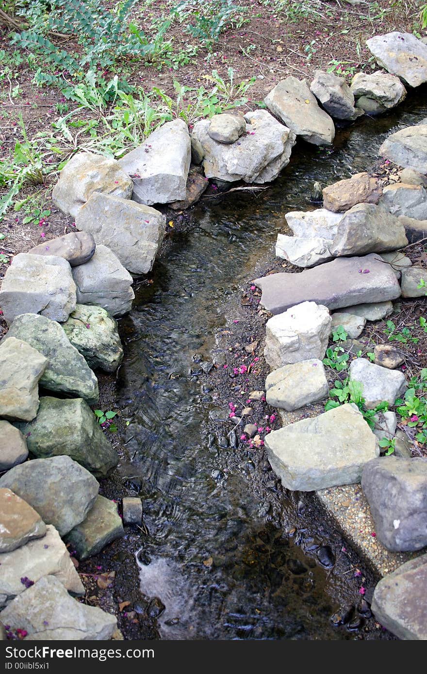 A stream winds through a landscaped garden. A stream winds through a landscaped garden.