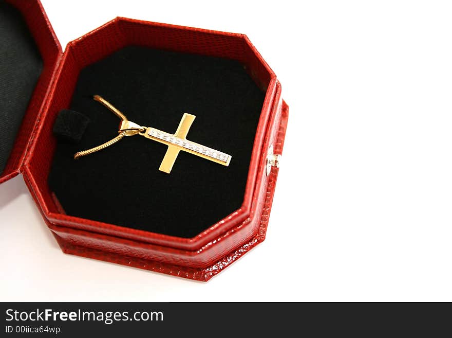 Golden and diamond cross in the jewelery box.