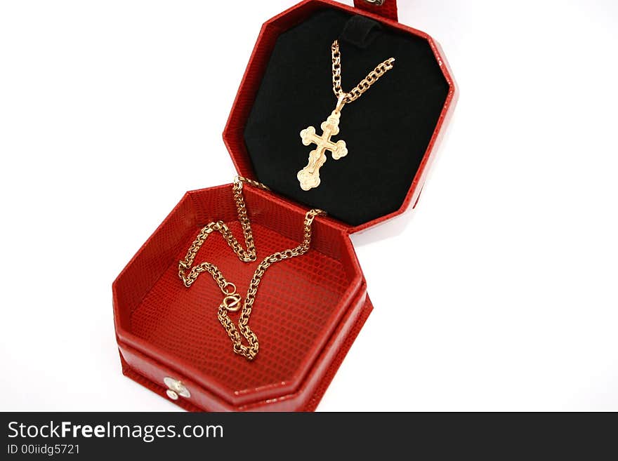 Golden cross and chain in the jewelery box.