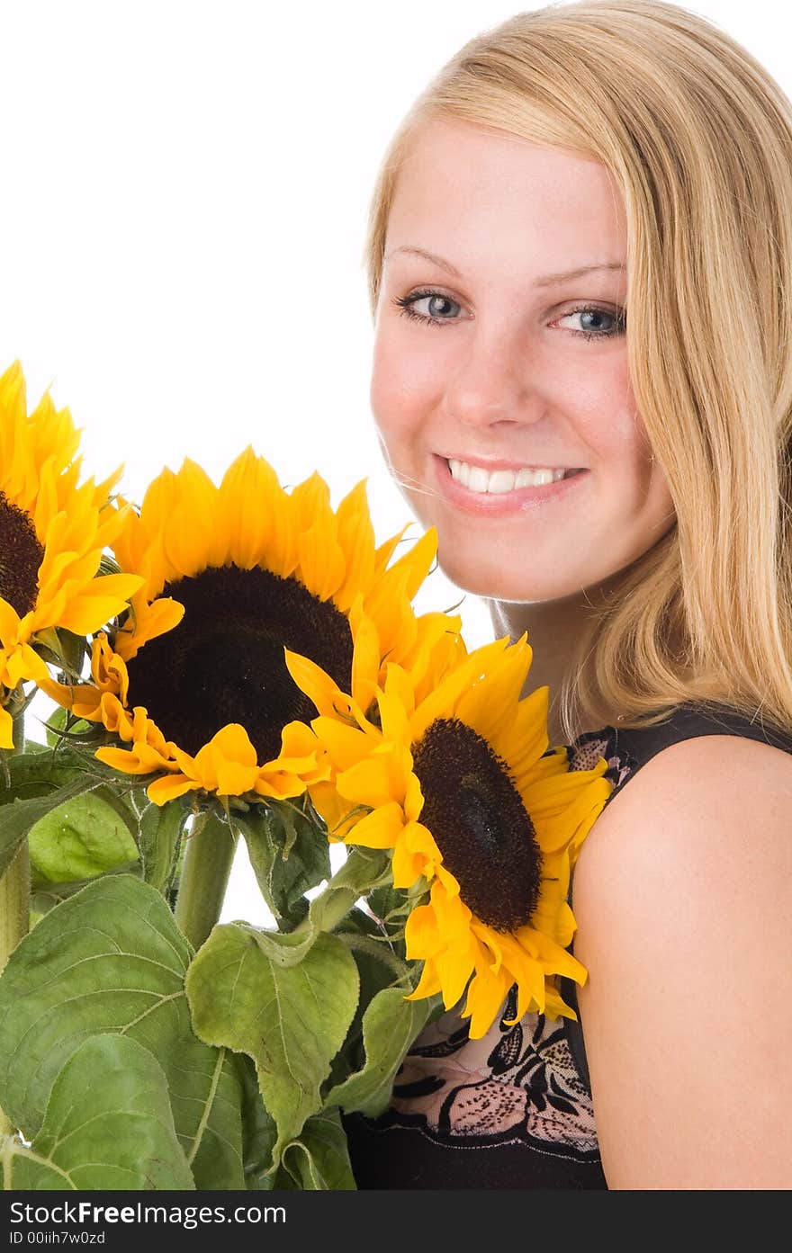 The attractive blonde in studio holds a sunflower in hands. The attractive blonde in studio holds a sunflower in hands