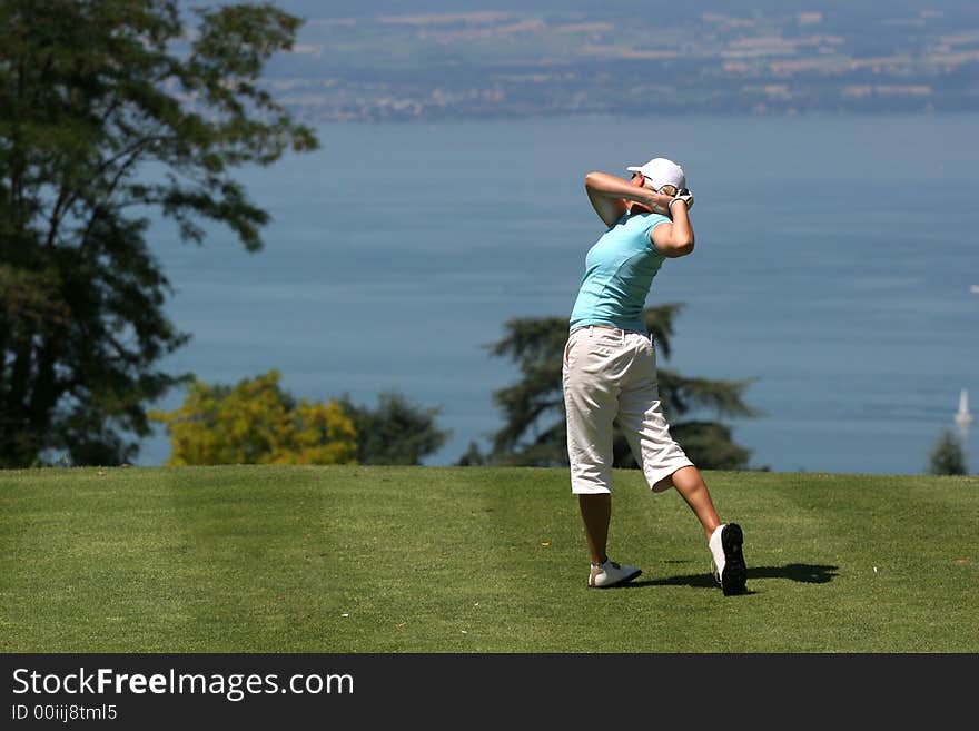 Lady golf swing at Leman lake