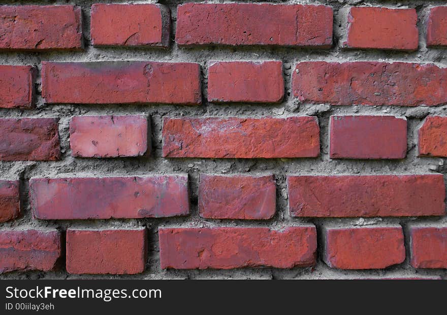 A decorative background; a wall from a red brick; a strong traditional building material. A decorative background; a wall from a red brick; a strong traditional building material.