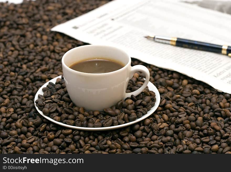 Coffe beans in cup on coffee background