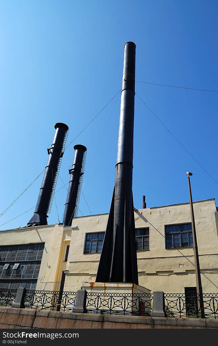 The old factory with a few big pipes.