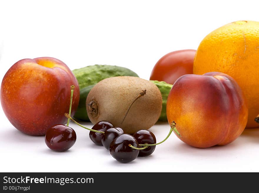 Exotic fruit on a white background. Still-life, fruit, grapes, kiwi, an orange, a peach, a sweet cherry,. Exotic fruit on a white background. Still-life, fruit, grapes, kiwi, an orange, a peach, a sweet cherry,