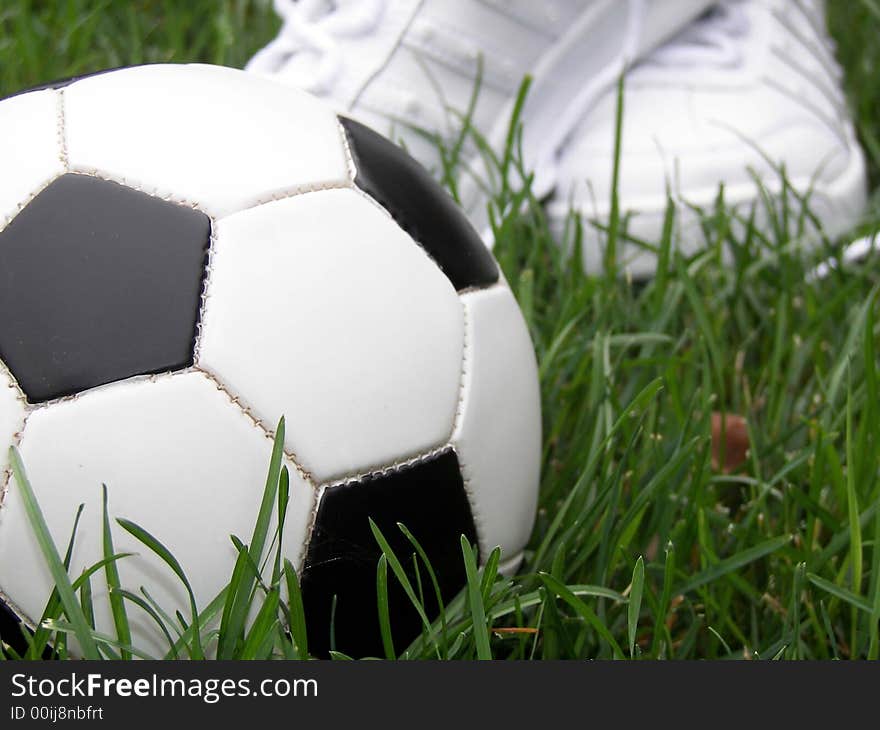 Soccer ball and new athletic shoes ready to play the game