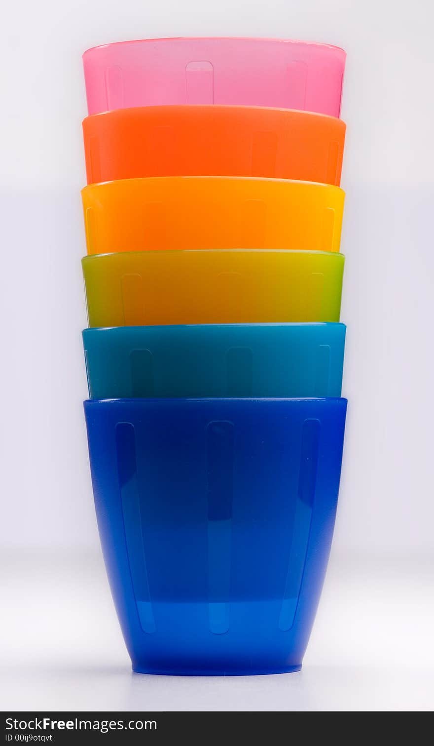 Colourfull plastic cups in a row, bright and cheery.