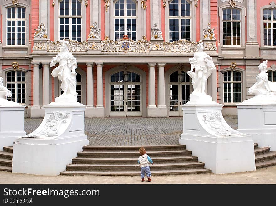 Little boy in front of a fancy manor. Little boy in front of a fancy manor