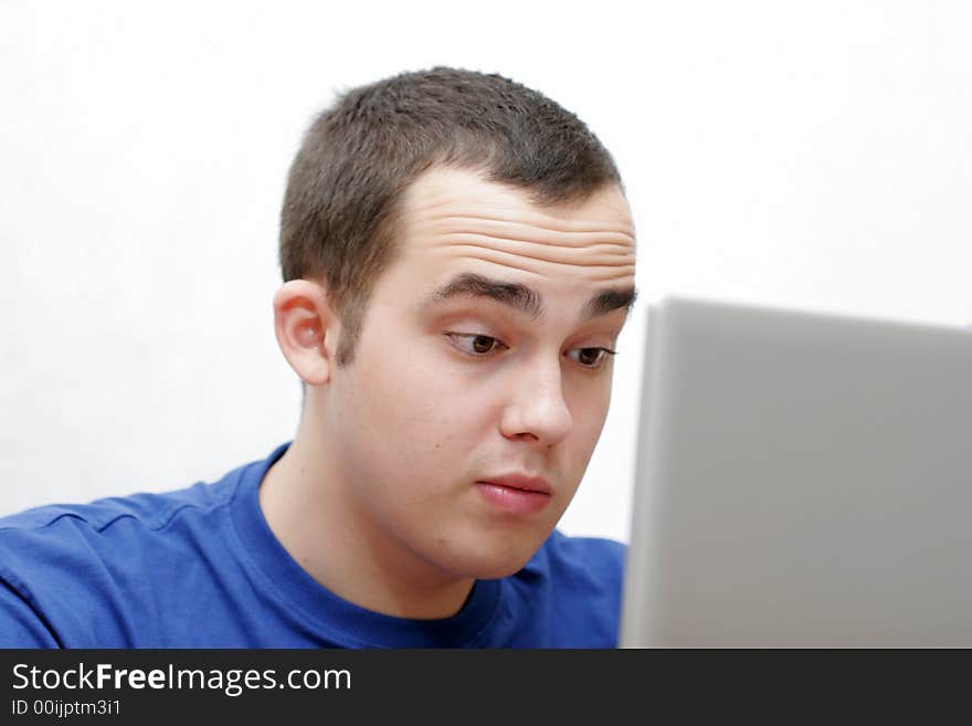 The student works on a portable computer. The student works on a portable computer