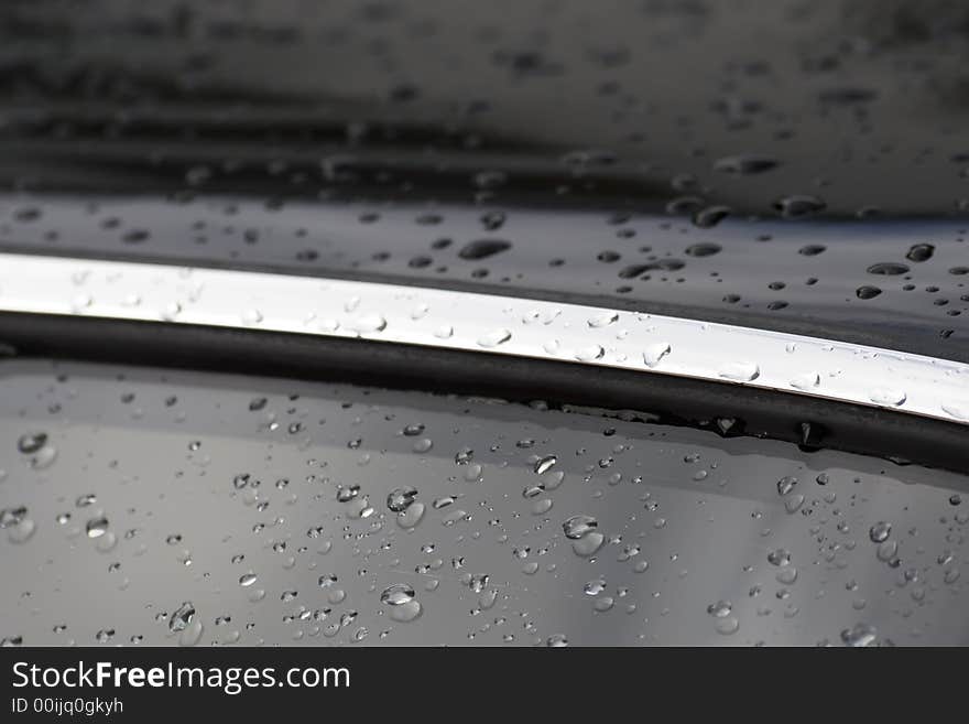 Water drops on black car surface. Water drops on black car surface.