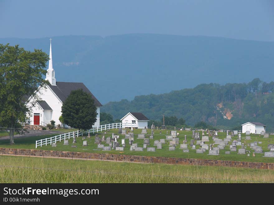 A Mountain countryside with a cemetery and church