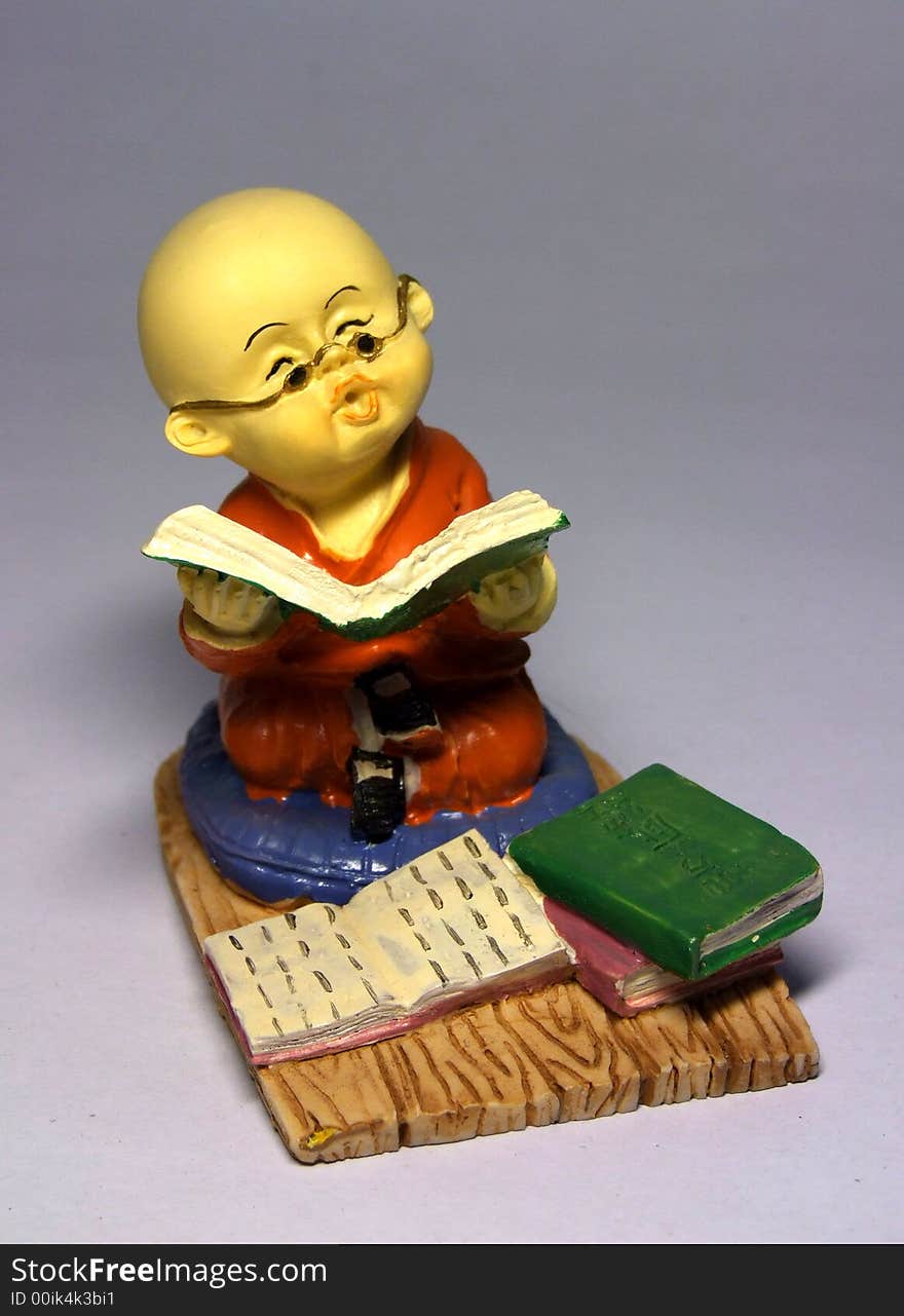 Sculpture of little monk reading book. Sculpture of little monk reading book.