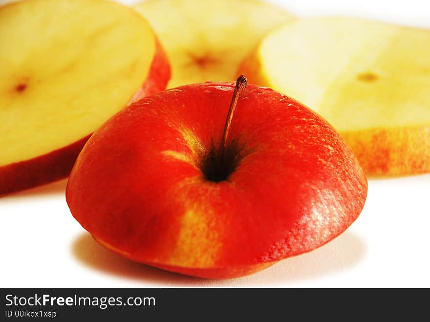 Red apple slices isolated on white background