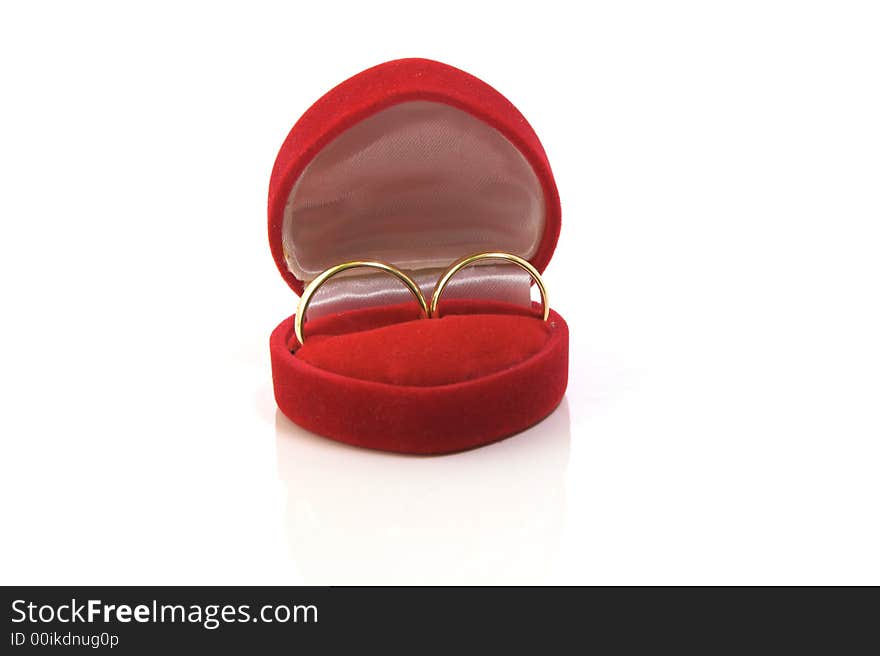 Gold wedding rings in red box isolated on white