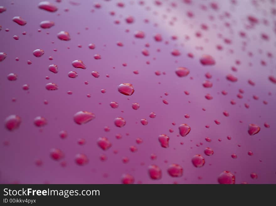 Water rain droplets on red glass background drop. Water rain droplets on red glass background drop