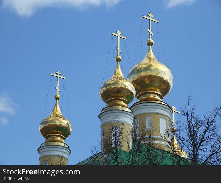 Domes of a orthodox temple on the background of a blue sky. Domes of a orthodox temple on the background of a blue sky