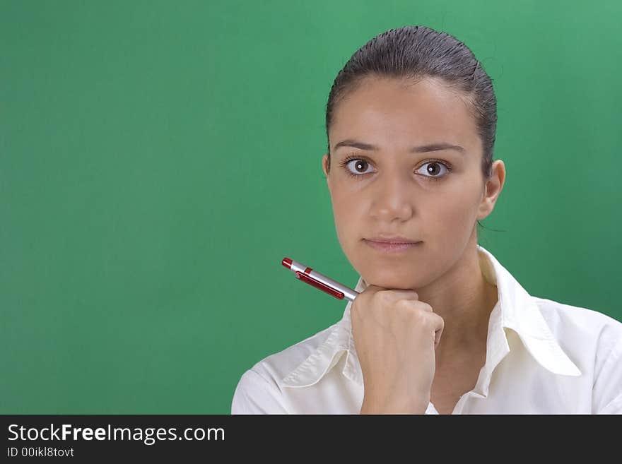 Young beautiful teacher in white on green background. Young beautiful teacher in white on green background