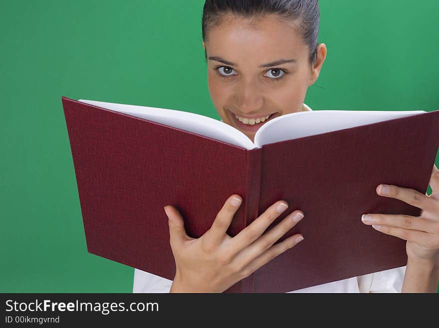 Young beautiful teacher in white on green background. Young beautiful teacher in white on green background