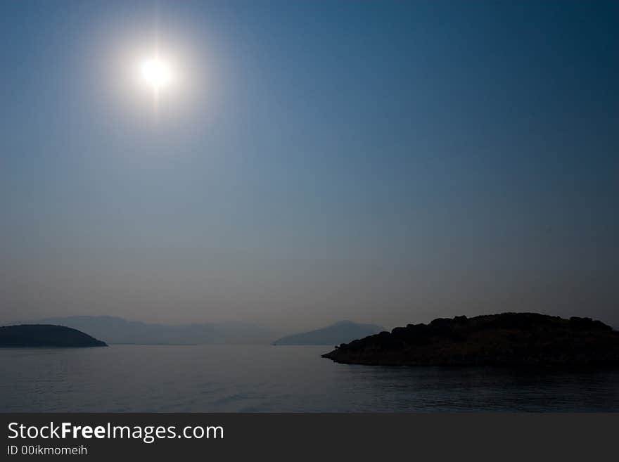 Sunny island near Greece shore in summer. Sunny island near Greece shore in summer