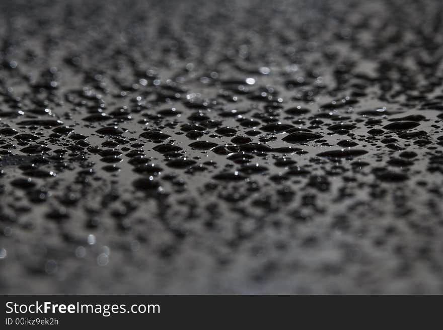 Water drops on a black surface