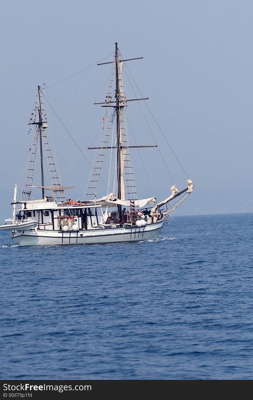 Old style white ship sailing in blue waters. Old style white ship sailing in blue waters