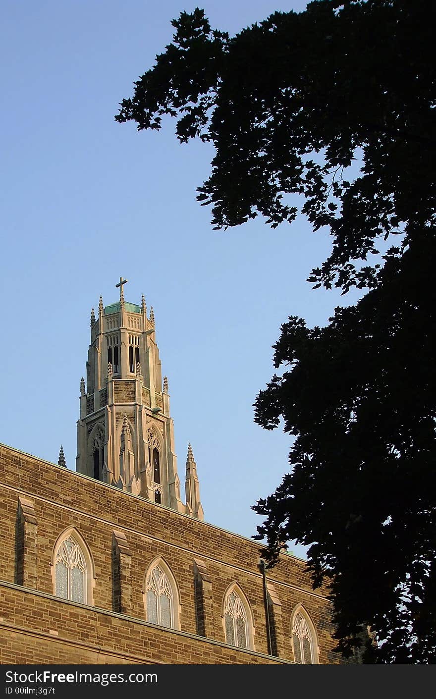 A church spire peeks over a building.