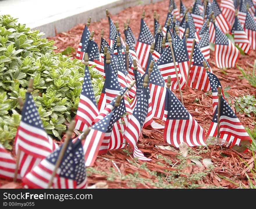 Small flags in front of a stone monument. Small flags in front of a stone monument