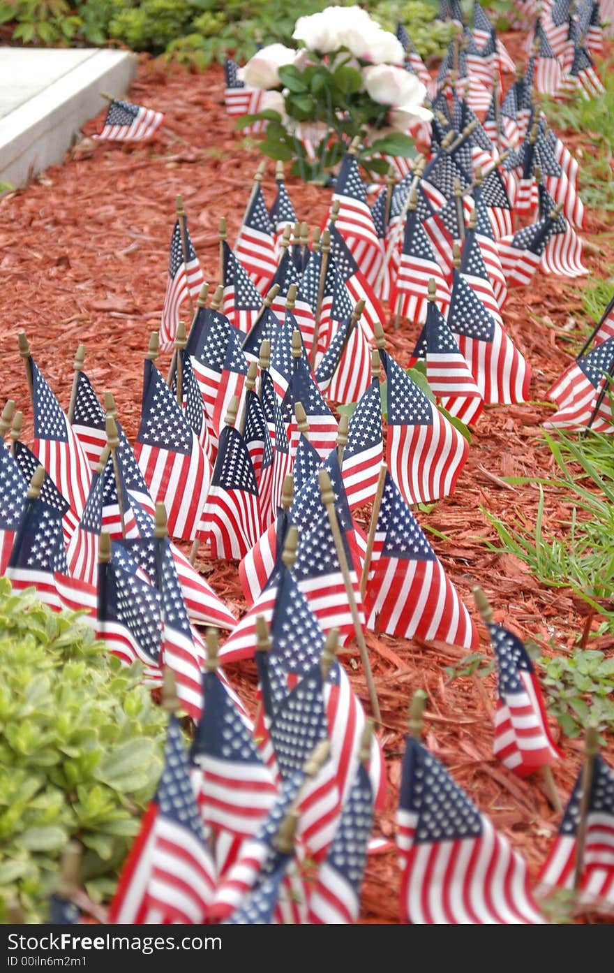 Small flags in front of a stone monument. Small flags in front of a stone monument