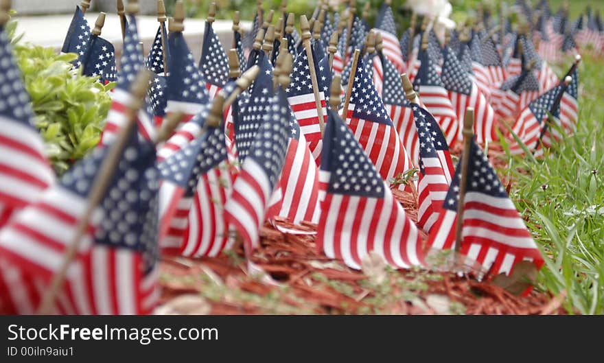 Small flags in front of a stone monument. Small flags in front of a stone monument