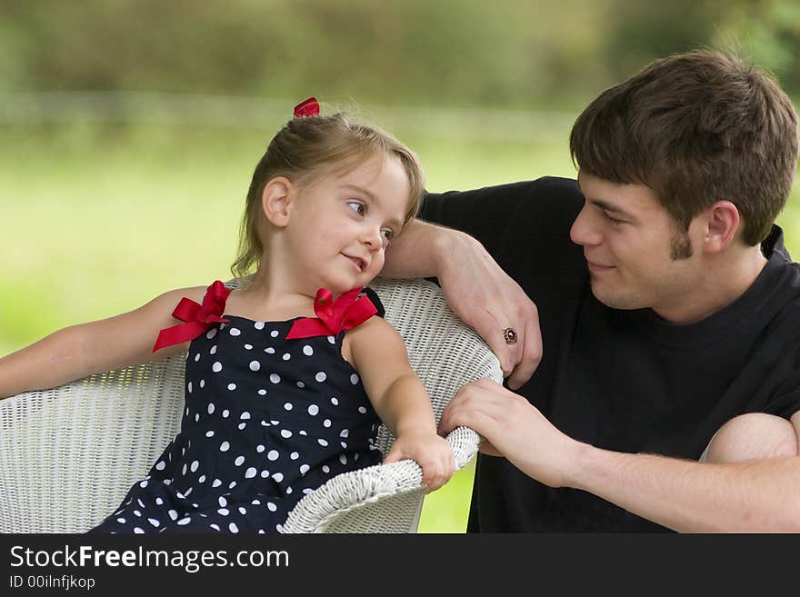 Little Girl Lovingly Views Young Man. Little Girl Lovingly Views Young Man