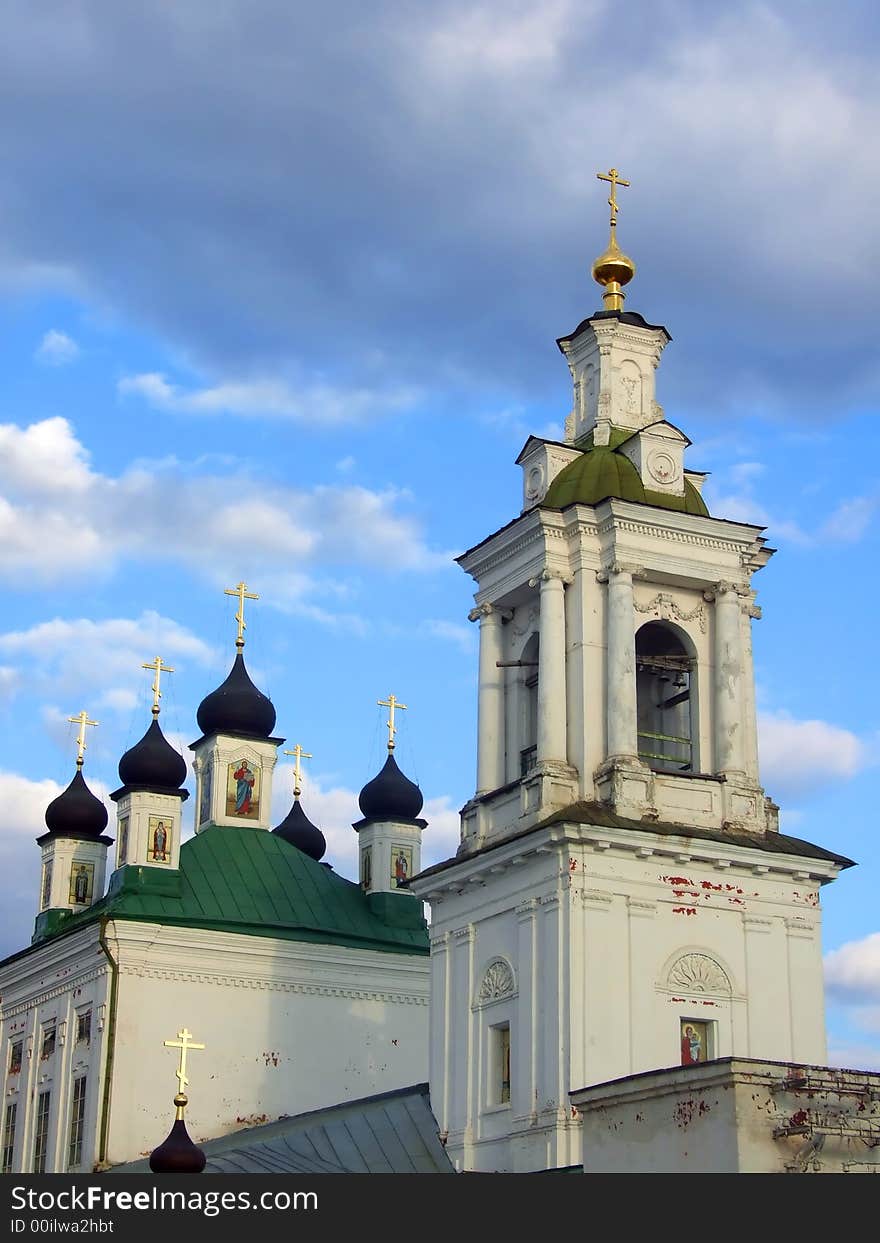 Old white orthodox church and celestial clouds