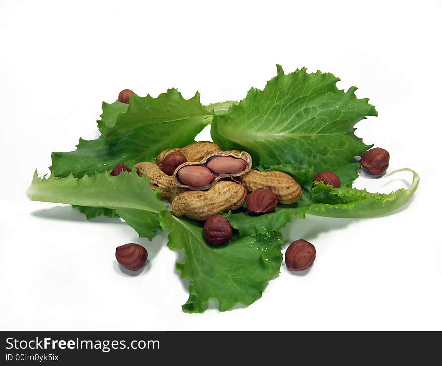 Leaves of a salad, peanuts and hazelnuts isolated. Leaves of a salad, peanuts and hazelnuts isolated