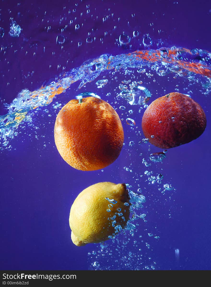 Citrus on a dark blue background in water. Citrus on a dark blue background in water