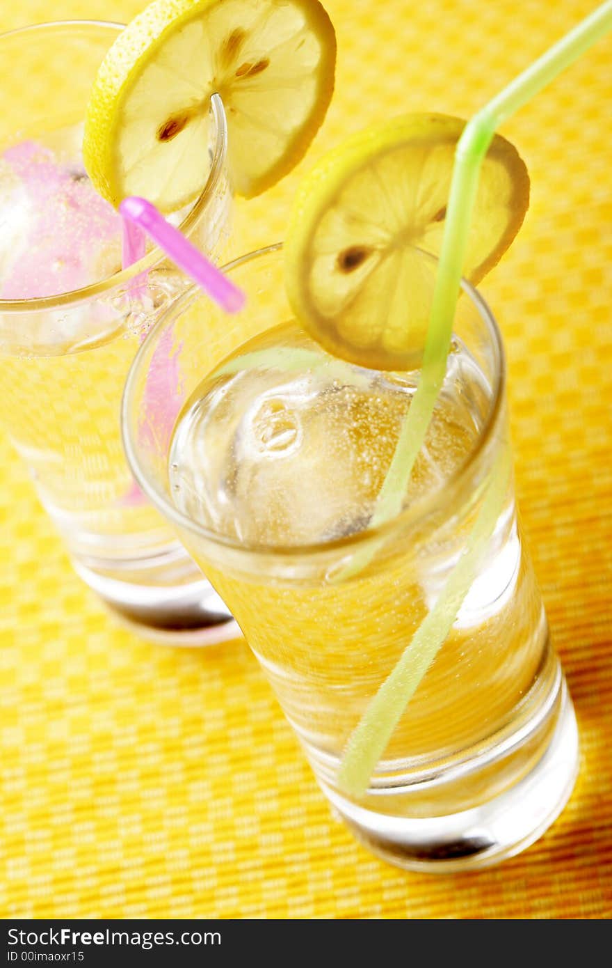 Water, sparkling, lemon, straw, glasses. Water, sparkling, lemon, straw, glasses