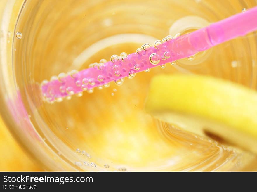 Water, sparkling, lemon, straw, glass. Water, sparkling, lemon, straw, glass