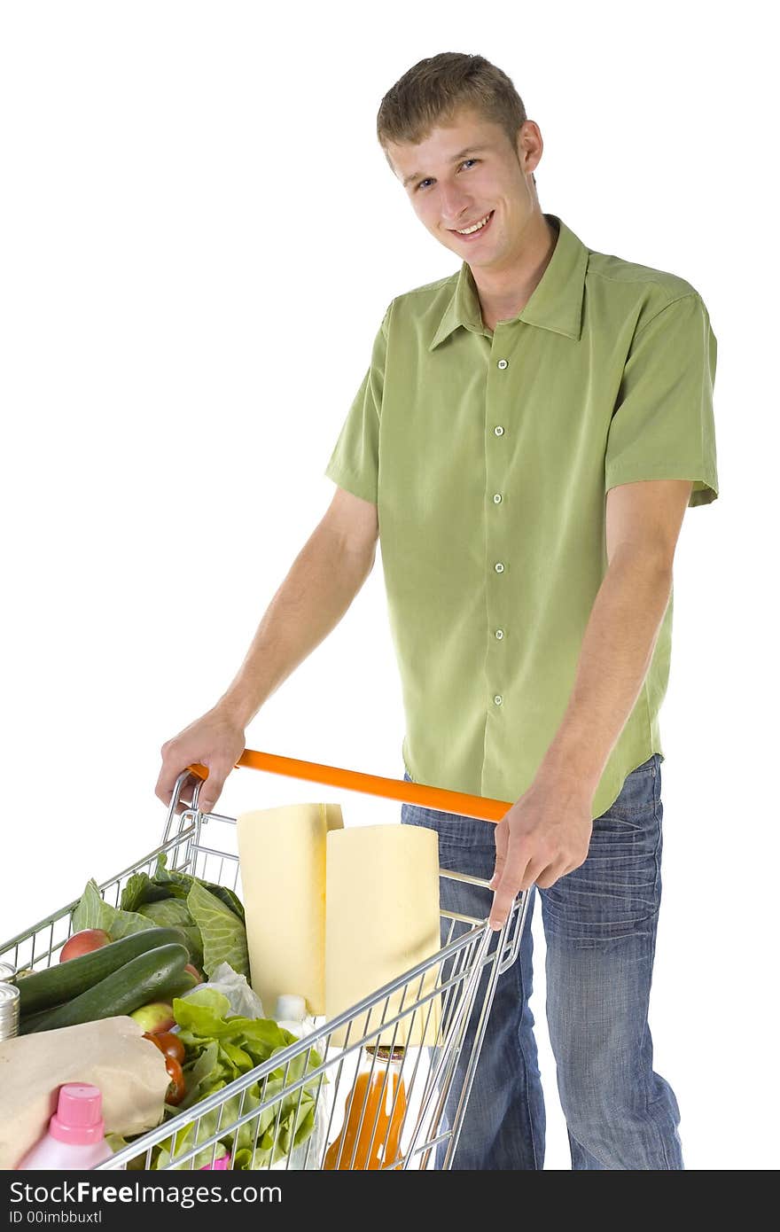 Young man standing with full of things trolley. Smiling and looking at camera. Young man standing with full of things trolley. Smiling and looking at camera