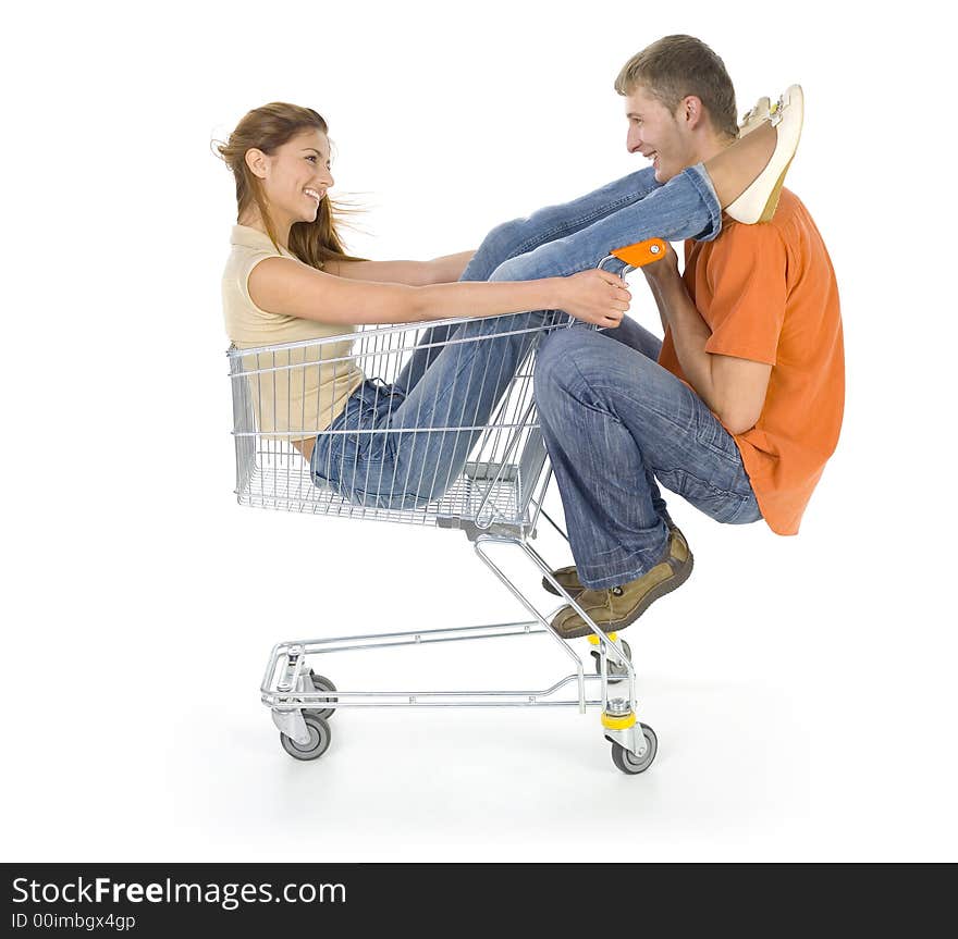 Young couple riding by trolley. Looking at each other. Isolated on white in studio. Side view, whole body. Young couple riding by trolley. Looking at each other. Isolated on white in studio. Side view, whole body