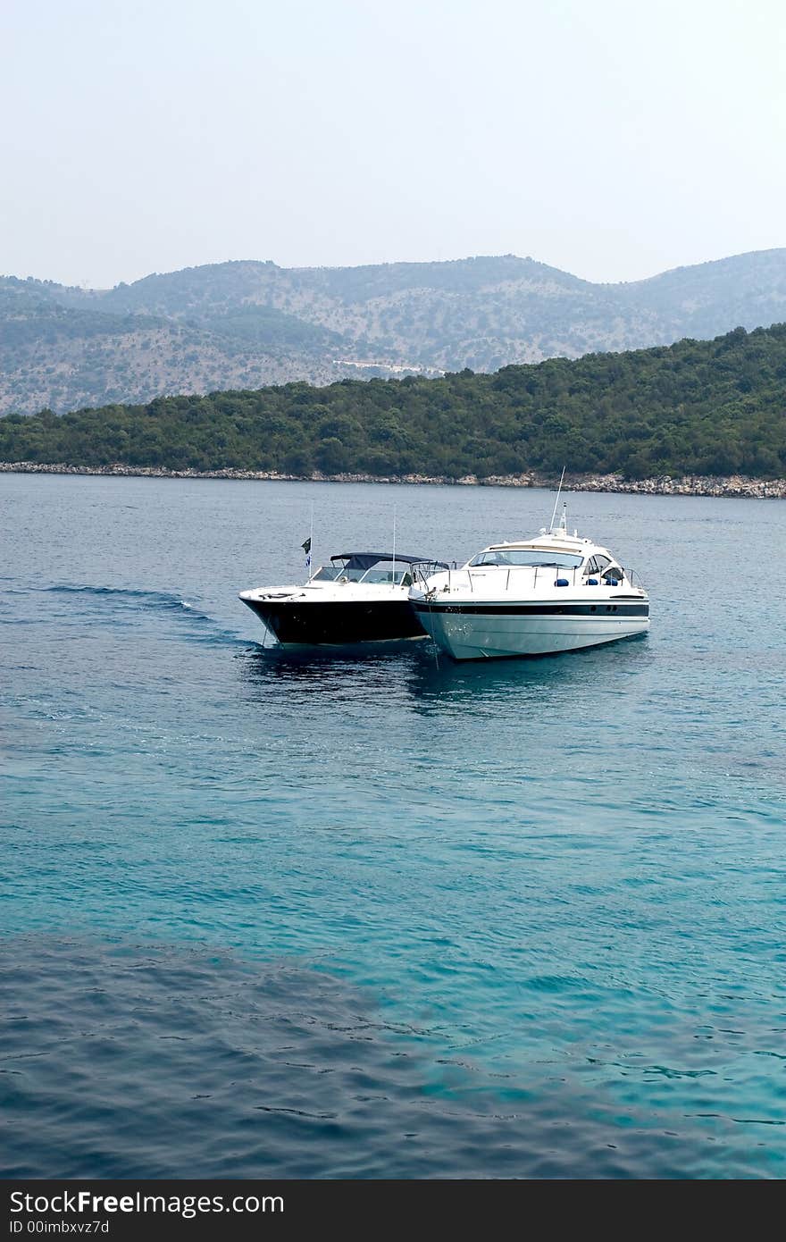 Blue and white luxury boats on sea. Blue and white luxury boats on sea