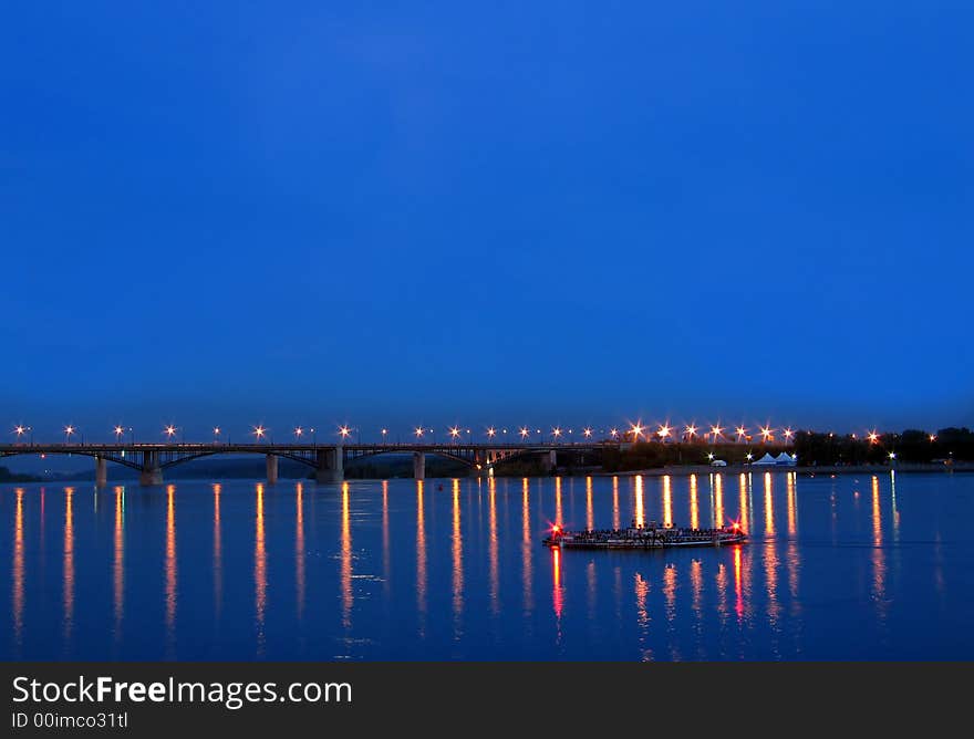 Night view on the bridge with illuminated light and reflection water