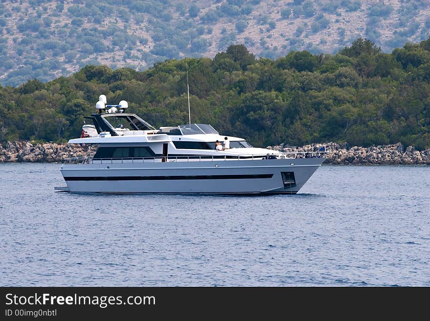 Luxury yacht on sea near olive tree forest