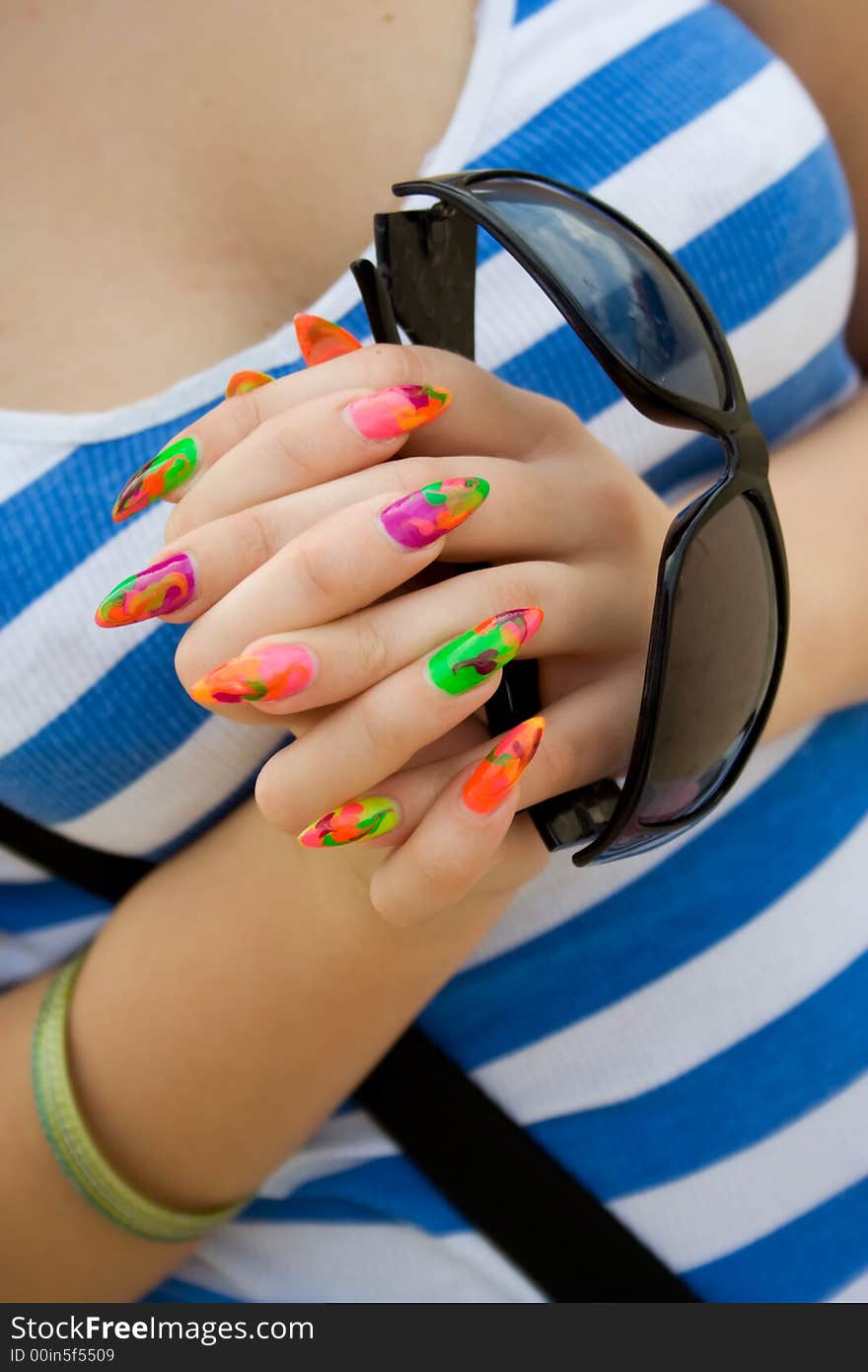 Girl holding sunglasses. Close-up shot. Girl holding sunglasses. Close-up shot.