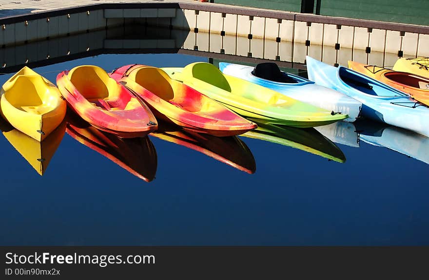 Colorful kayaks reflecting on a river in Oregon. Colorful kayaks reflecting on a river in Oregon