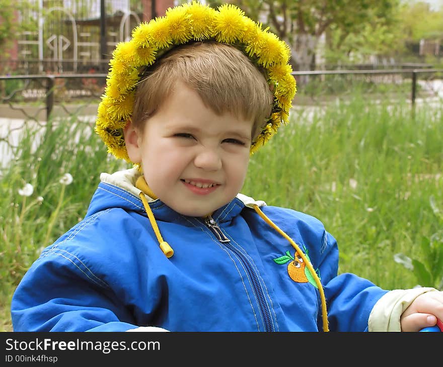 A fun boy with a dandelion garland