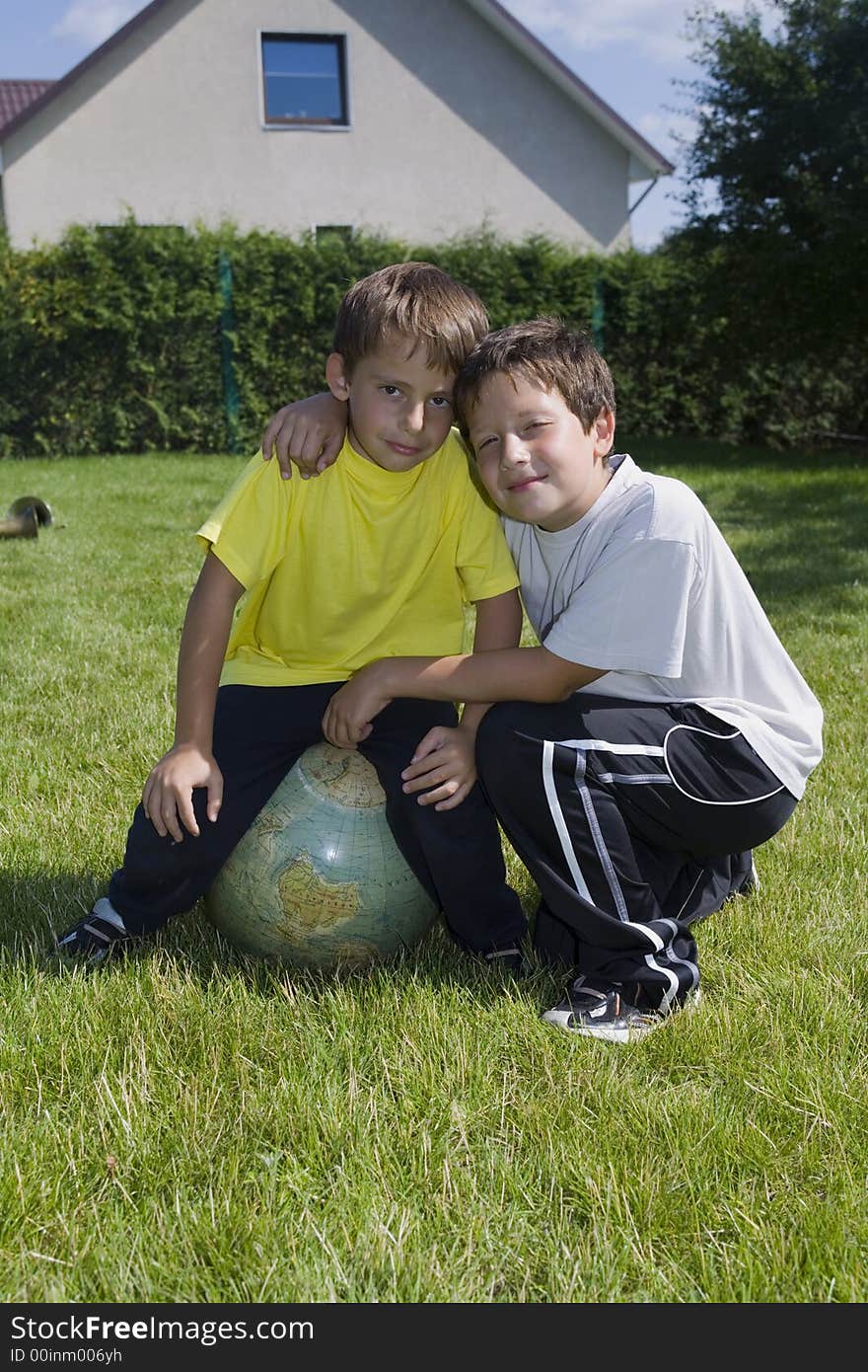 Brothers and globe on lawn in courtyard of the building