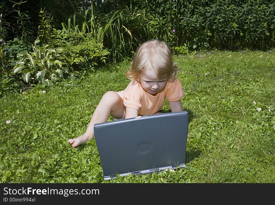 Girl study on computer on lawn