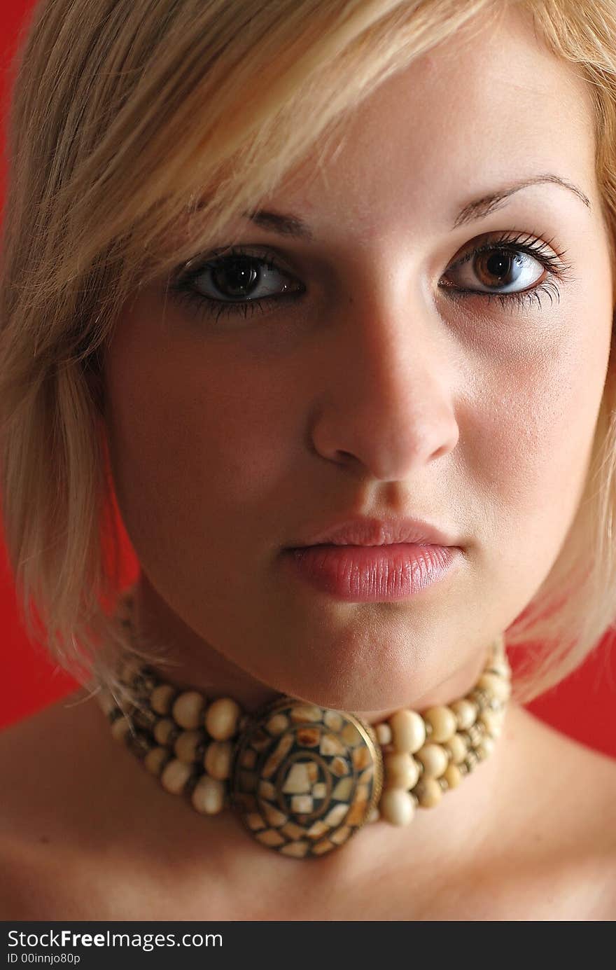 Cute blond girl looking and posing with necklace