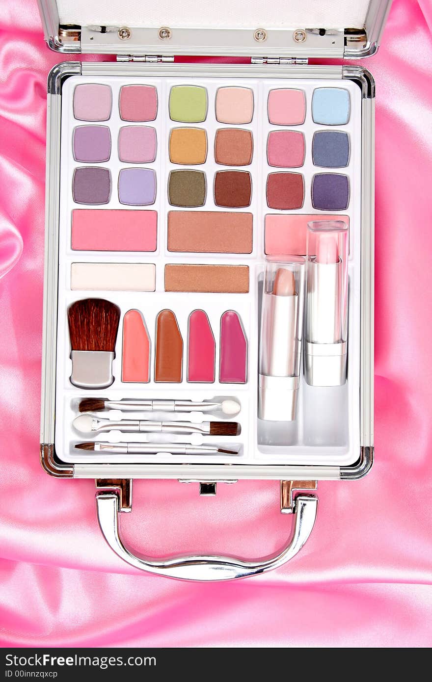 Makeup briefcase on pink satin