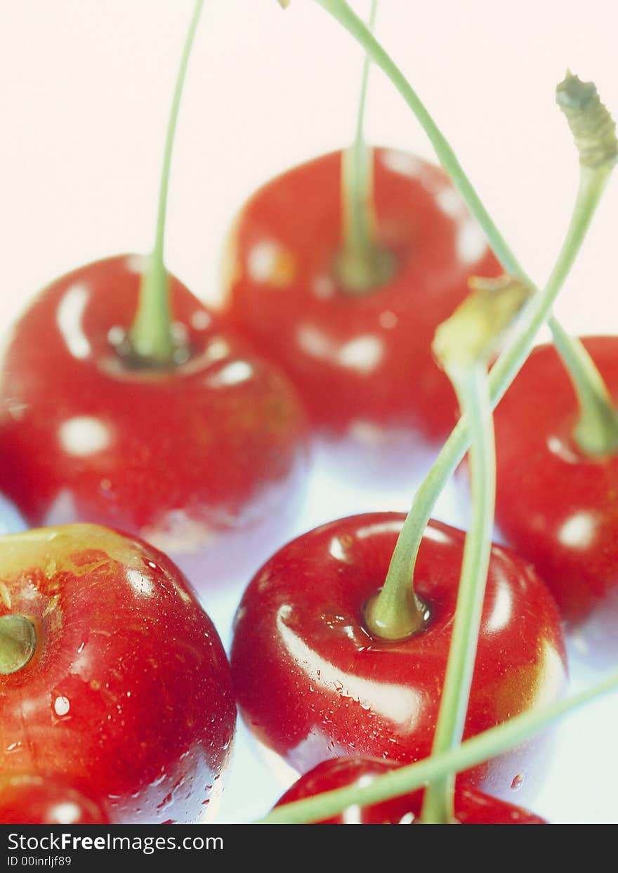 Red cherry laying on a white background