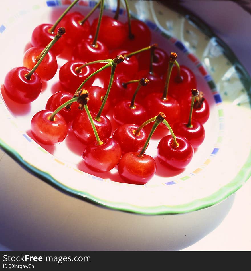 Red cherries costing on a plate. Red cherries costing on a plate