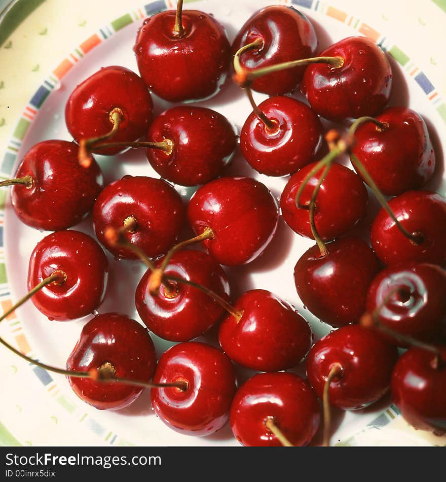 Red cherries costing on a plate. Red cherries costing on a plate